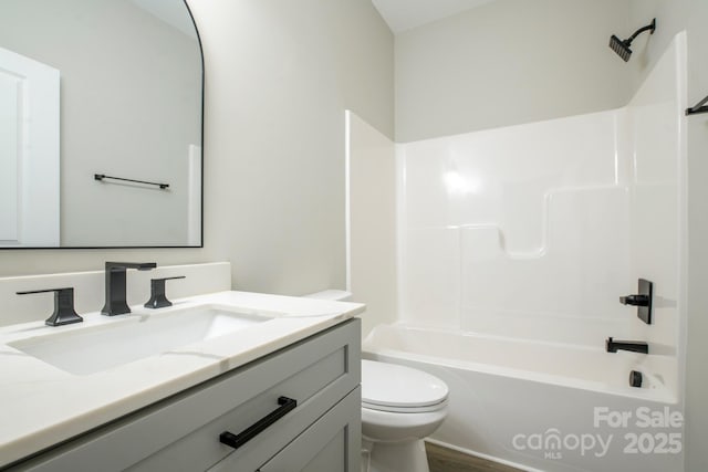 full bathroom featuring vanity,  shower combination, and toilet