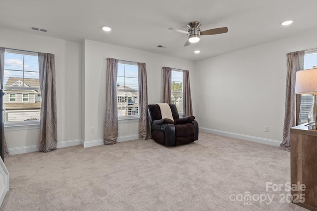 sitting room with visible vents, ceiling fan, and carpet flooring