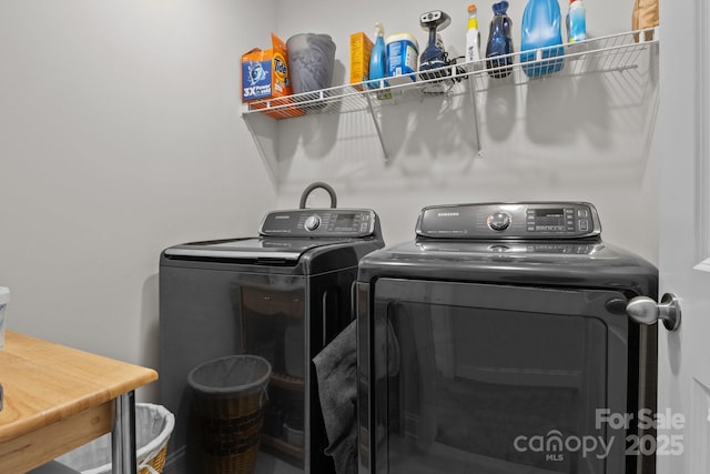 clothes washing area featuring laundry area and washer and clothes dryer