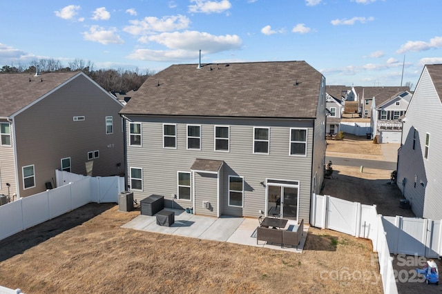 rear view of house with a patio area, a fenced backyard, a yard, and a gate