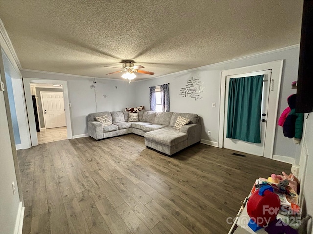 living area featuring a textured ceiling, ornamental molding, and wood finished floors