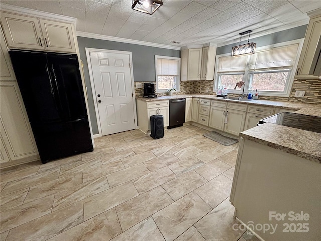 kitchen with pendant lighting, tasteful backsplash, light countertops, cream cabinets, and black appliances