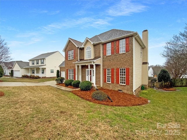 view of front of home featuring brick siding, driveway, crawl space, a chimney, and a front yard