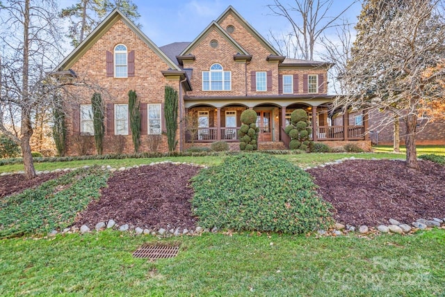 view of front facade with a front lawn and a porch