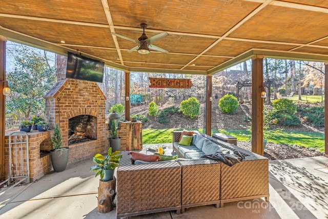 view of patio featuring ceiling fan and an outdoor living space with a fireplace