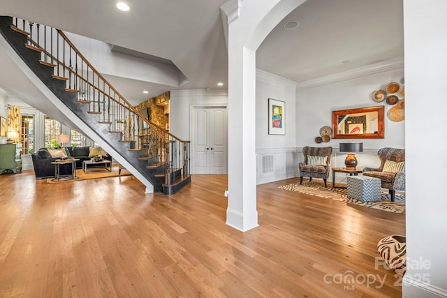 entryway featuring ornamental molding and hardwood / wood-style flooring