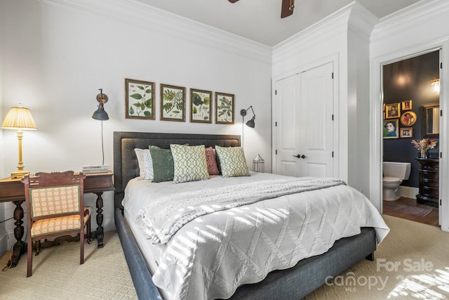 carpeted bedroom with ceiling fan, ornamental molding, ensuite bath, and a closet