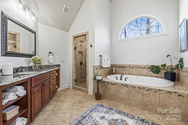 bathroom featuring tile patterned flooring, vaulted ceiling, vanity, and shower with separate bathtub