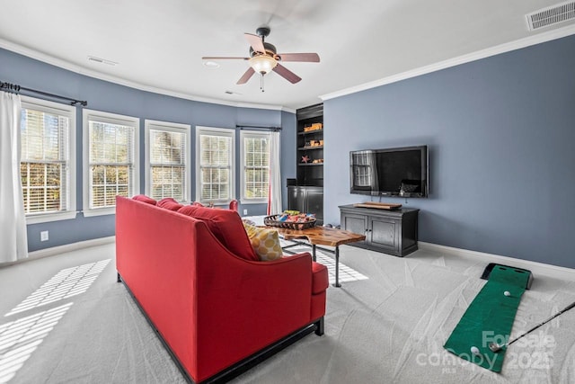 carpeted living room featuring ceiling fan and ornamental molding