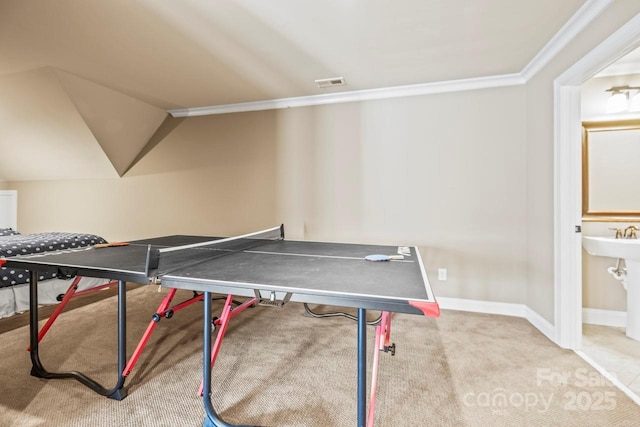 rec room featuring vaulted ceiling, crown molding, and light carpet