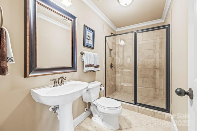 bathroom featuring tile patterned floors, crown molding, toilet, and a shower with door