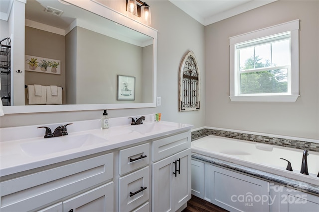 bathroom featuring a bath, double vanity, a sink, and visible vents