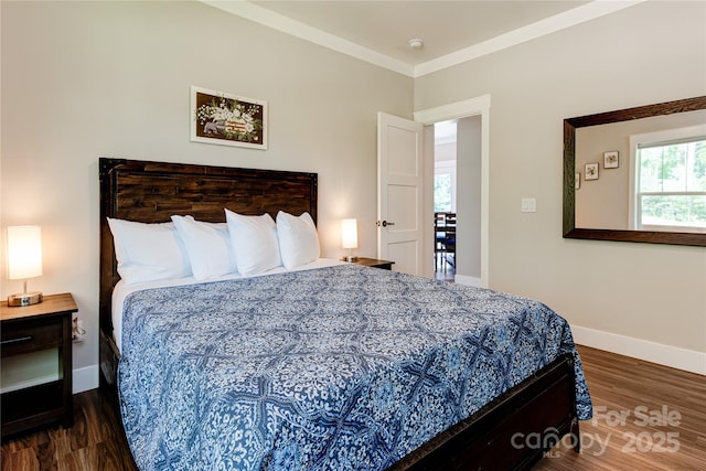 bedroom with baseboards, ornamental molding, and wood finished floors