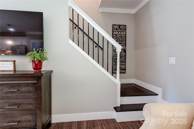 stairway featuring wood finished floors and baseboards