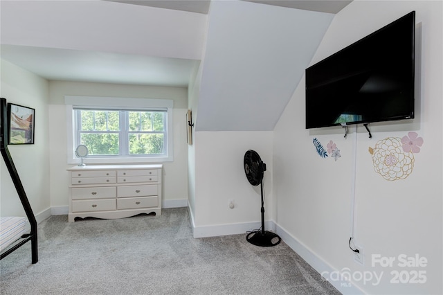 carpeted bedroom featuring vaulted ceiling and baseboards