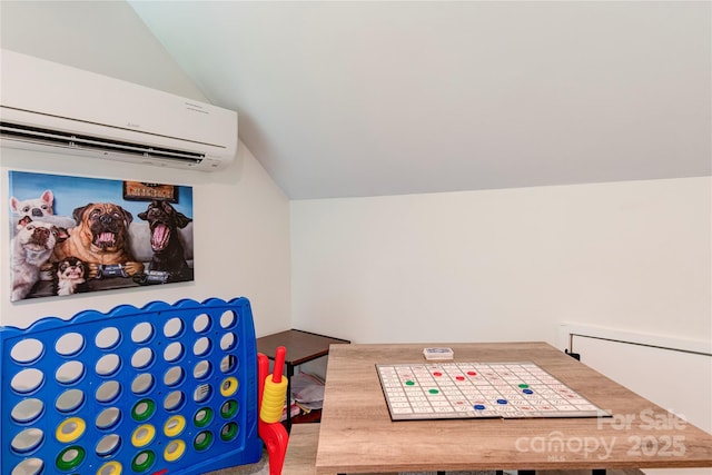 playroom featuring lofted ceiling and a wall unit AC