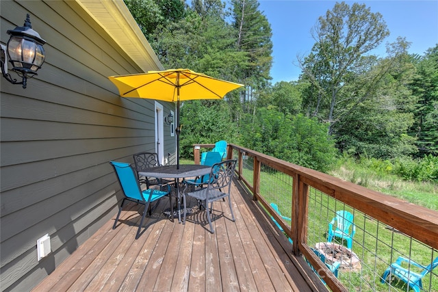 wooden terrace featuring outdoor dining space