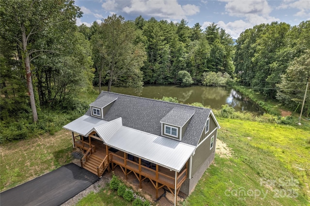 birds eye view of property with a water view and a view of trees