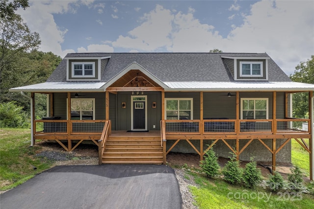 view of front of property with a ceiling fan, covered porch, roof with shingles, and metal roof