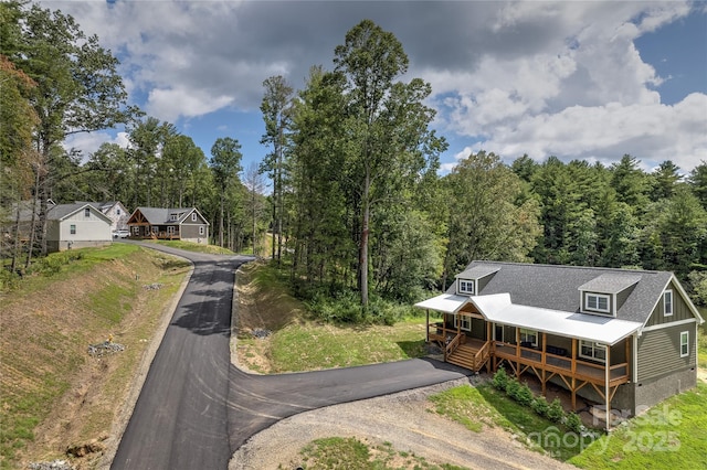 drone / aerial view with a wooded view