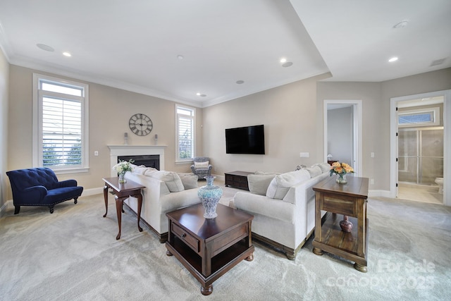 living room with visible vents, light carpet, ornamental molding, a fireplace, and baseboards