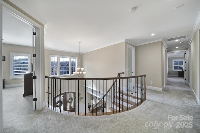 corridor featuring an upstairs landing, a notable chandelier, visible vents, and carpet floors