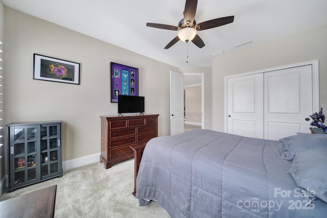 bedroom with carpet flooring, a ceiling fan, visible vents, and a closet