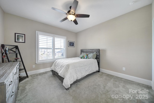 bedroom featuring light carpet, ceiling fan, and baseboards