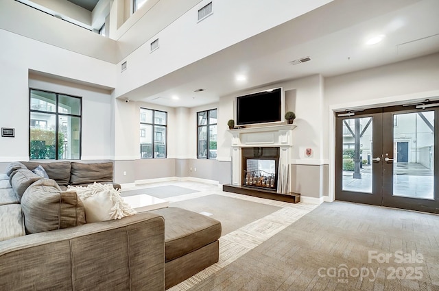 living room with a high ceiling and french doors