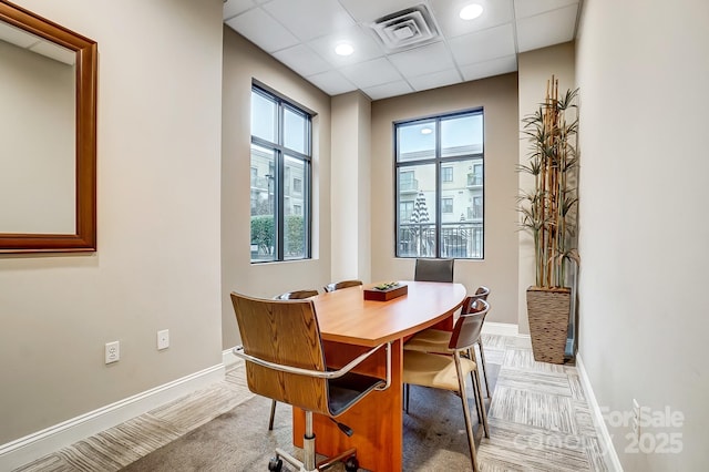 dining space with a paneled ceiling