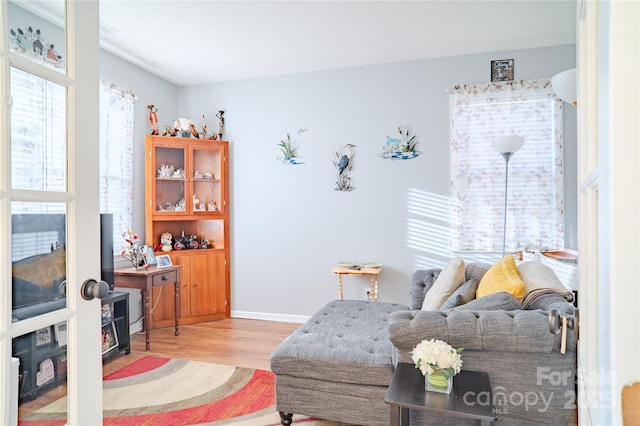 living area with wood finished floors and baseboards