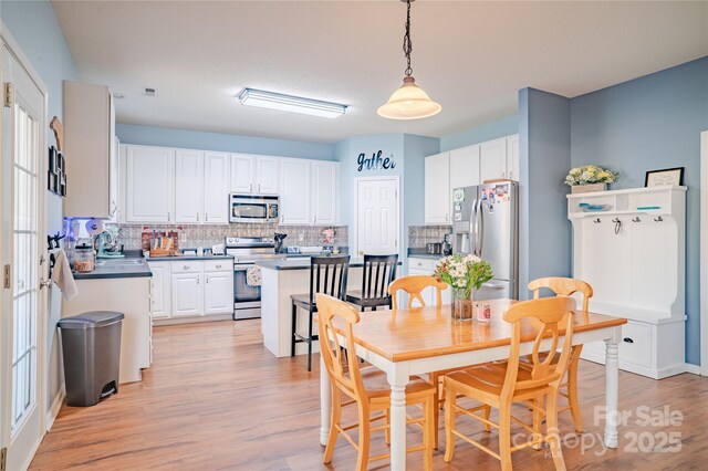 dining space with light wood-type flooring