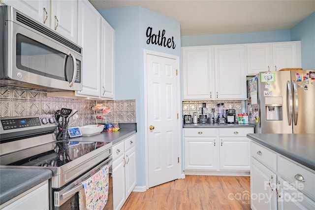 kitchen featuring light wood-style floors, tasteful backsplash, appliances with stainless steel finishes, and white cabinets