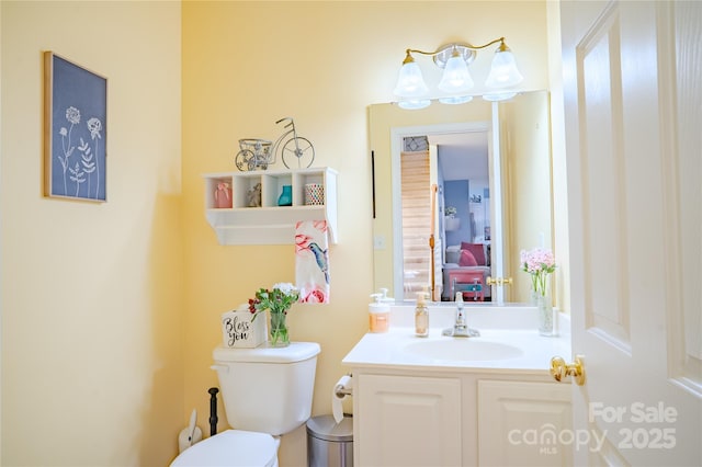 bathroom featuring vanity and toilet