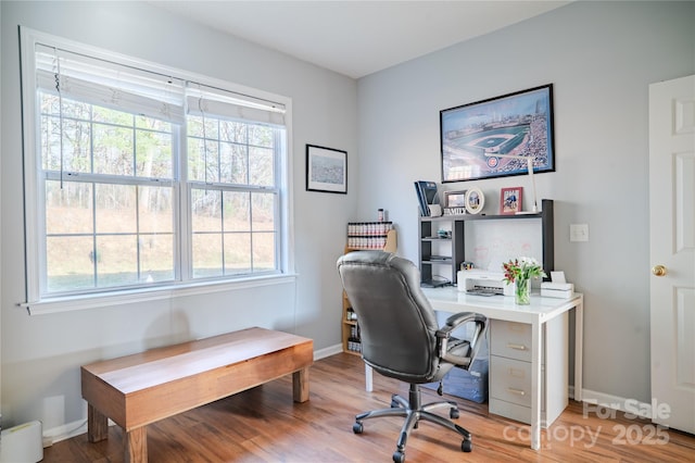 office area with baseboards and wood finished floors