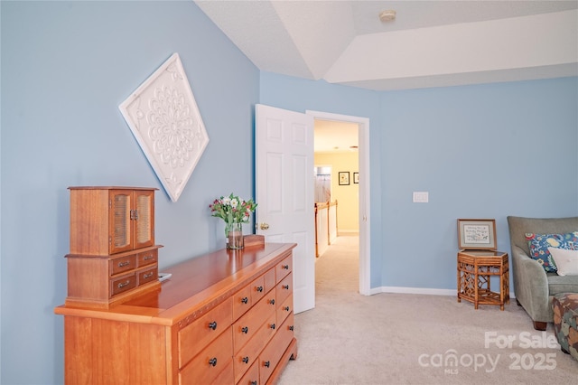 bedroom featuring light colored carpet and baseboards