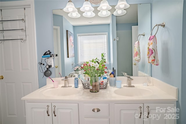 full bathroom featuring double vanity and a sink