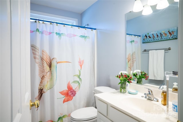 bathroom with toilet, curtained shower, and vanity