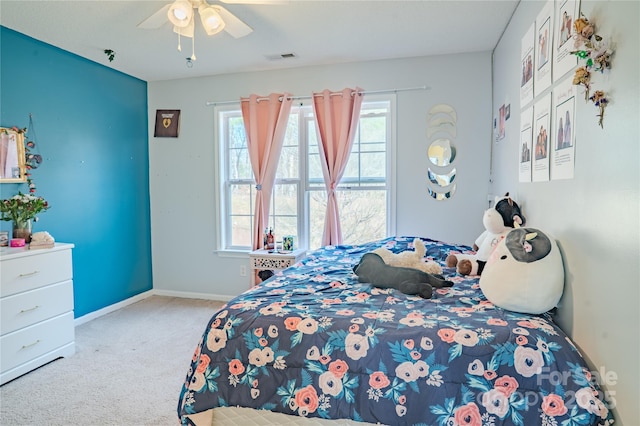 bedroom featuring ceiling fan, carpet flooring, visible vents, and baseboards