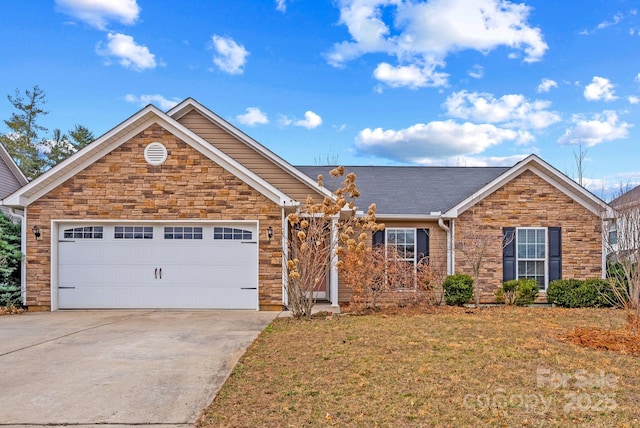 front of property with a garage and a front lawn