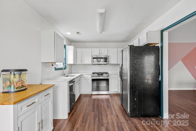 kitchen featuring tasteful backsplash, stainless steel appliances, sink, and white cabinets