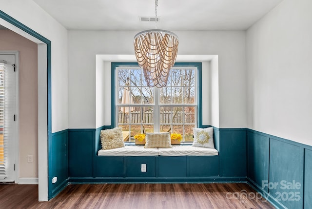 interior space featuring dark hardwood / wood-style floors and an inviting chandelier