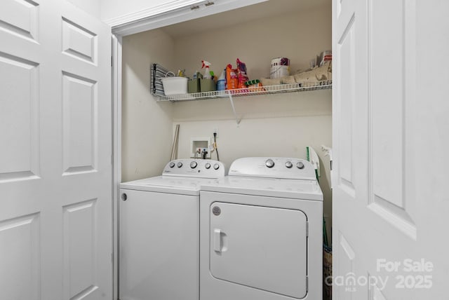 washroom with washing machine and clothes dryer