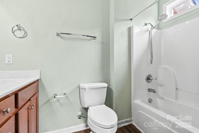 full bathroom with vanity, hardwood / wood-style floors, shower / tub combination, and toilet