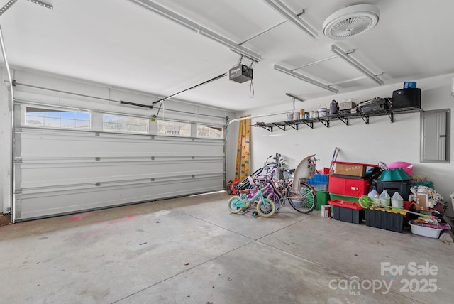 garage featuring a garage door opener and electric panel