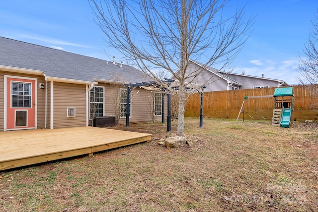 view of yard with a wooden deck and a playground