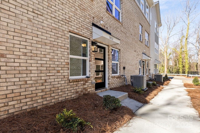 doorway to property featuring central AC unit