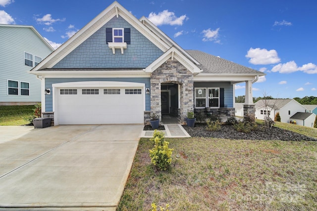 craftsman house featuring covered porch and a garage