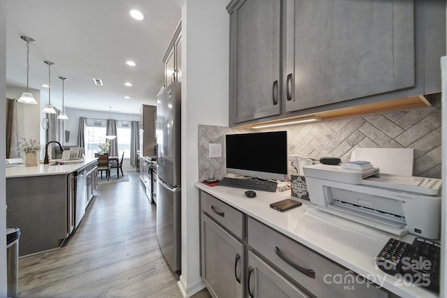 5239 Admirals Lndg, Lancaster, SC 29720 - kitchen featuring light hardwood / wood-style flooring, hanging light fixtures, stainless steel appliances, backsplash, and gray cabinets