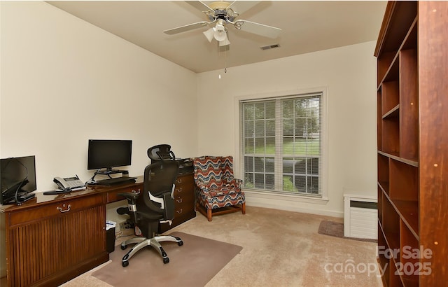 office with light colored carpet and ceiling fan